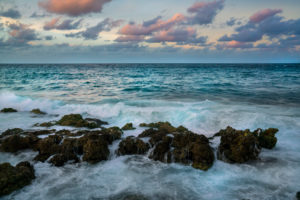turquoise coloured sea with rock in the foreground and pink coloured clouds, at the blue hour, Malecon in Havana, Cuba turquoise coloured sea with rock in the foreground and pink coloured clouds, at the blue hour, Malecon in Havana, Cuba